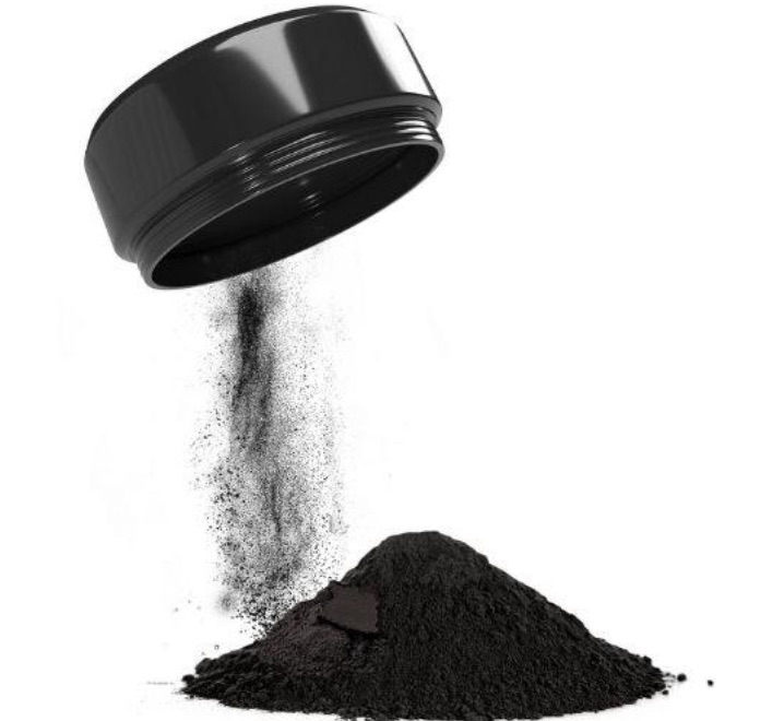 Fine powdered activated carbon being poured onto a clean surface