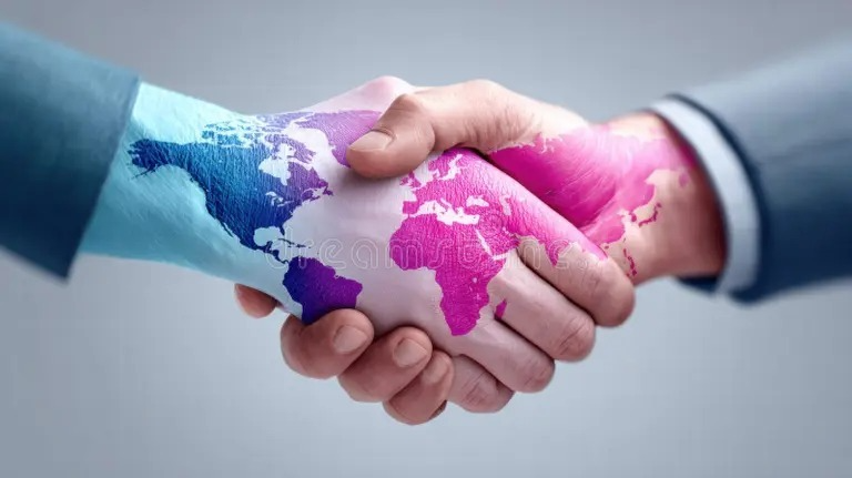 A handshake in front of a world map, representing strategic global partnership